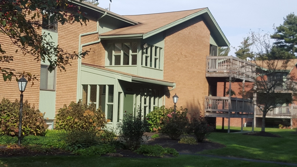 30 Parish Pathe, Unit 30 Marshfield, MA 02050 - Photo 10 of 11 a front view of a house with a yard and trees
