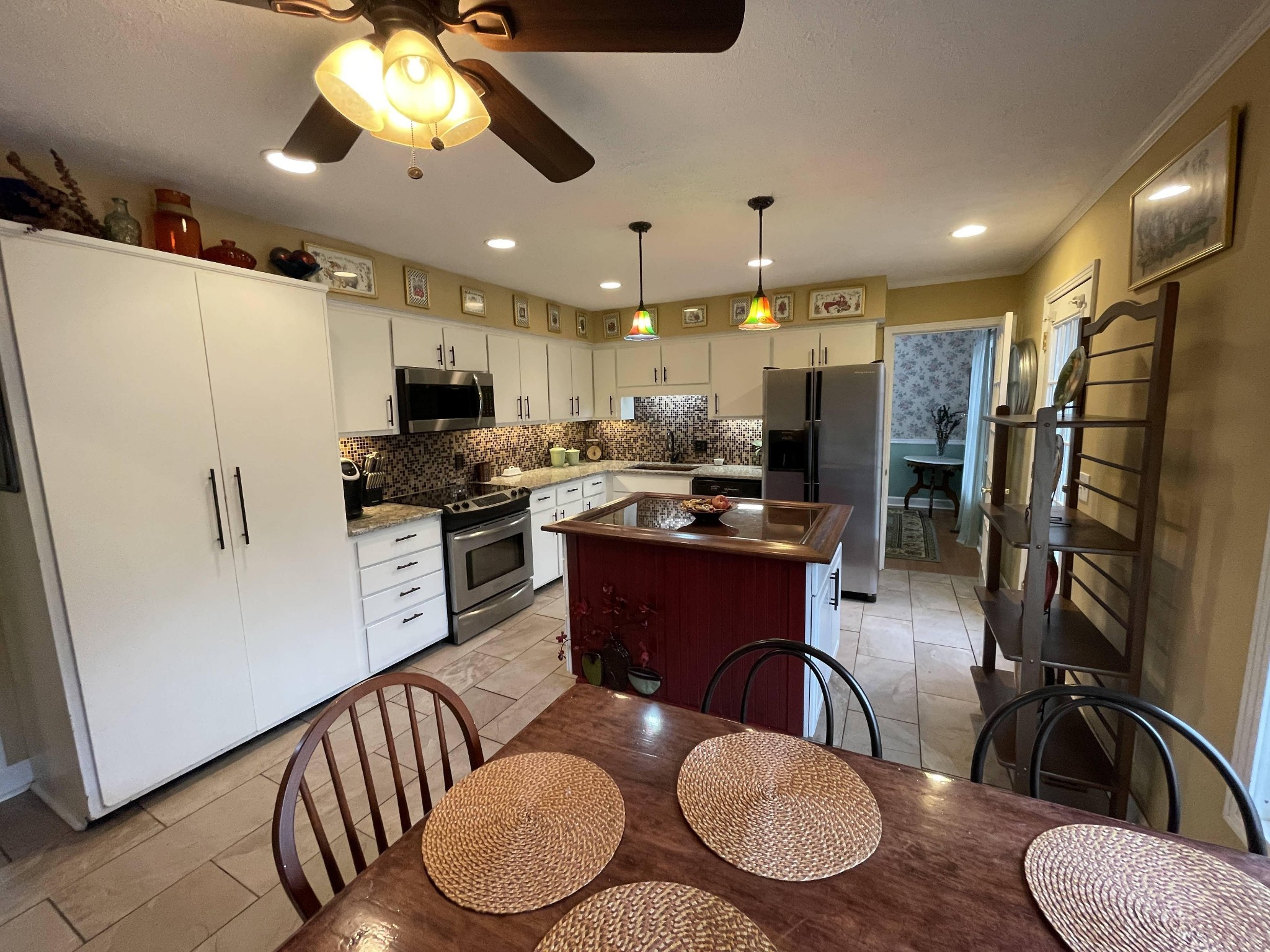 5131 Hickory Ridge Road Lebanon, TN 37090 - Photo 8 of 19 a kitchen with stainless steel appliances kitchen island granite countertop a refrigerator a stove top oven a sink with island and chairs