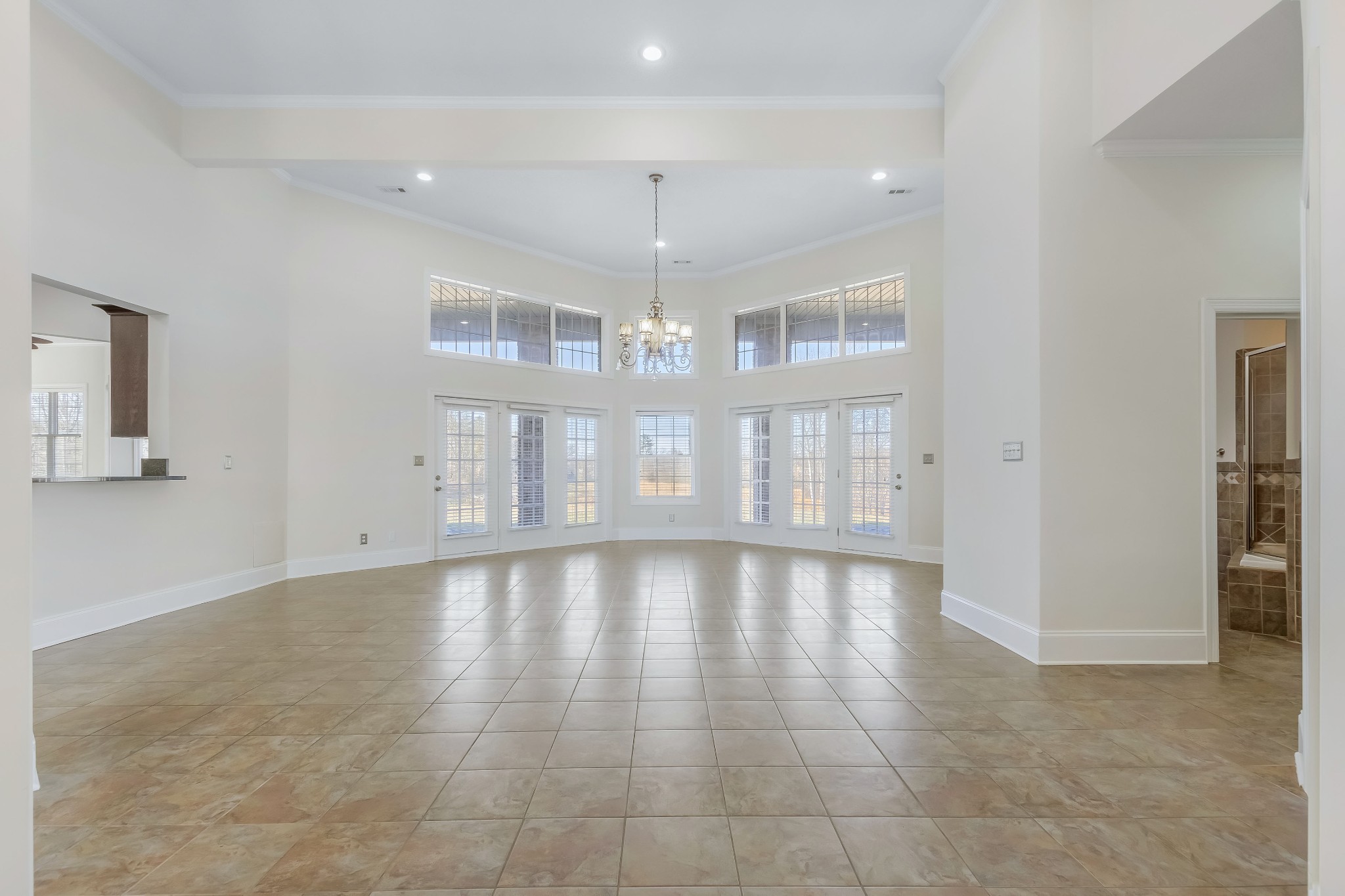 555 Randall Hitchcock Road Rock Island, TN 38581 - Photo 5 of 86 a view of an empty room with chandelier fan and kitchen view