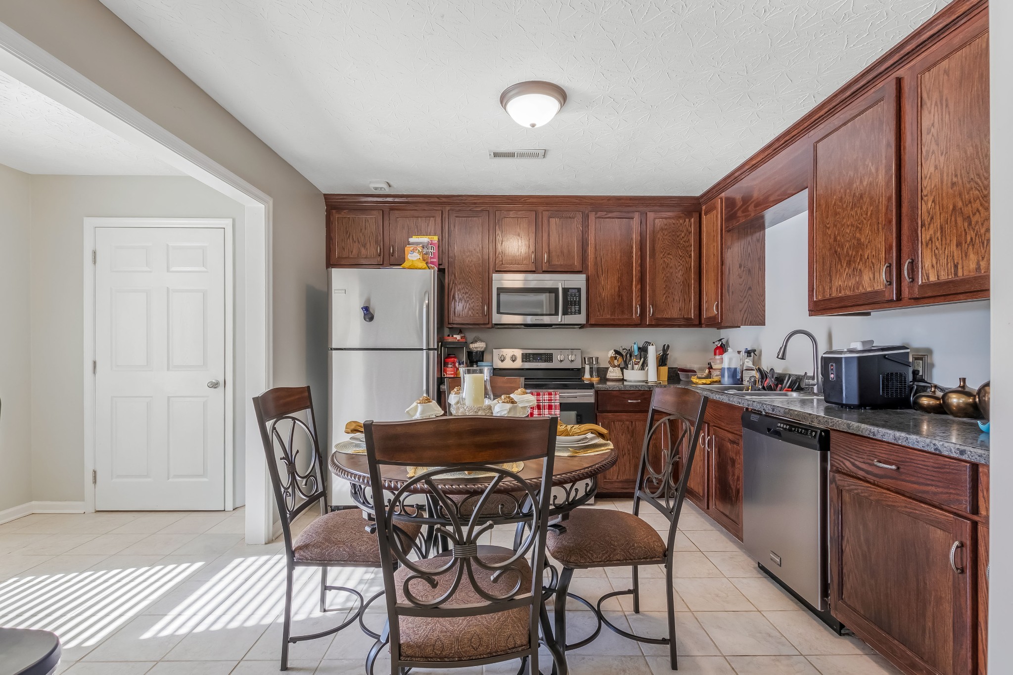 555 Randall Hitchcock Road Rock Island, TN 38581 - Photo 65 of 86 a kitchen with stainless steel appliances granite countertop a dining table chairs refrigerator and cabinets
