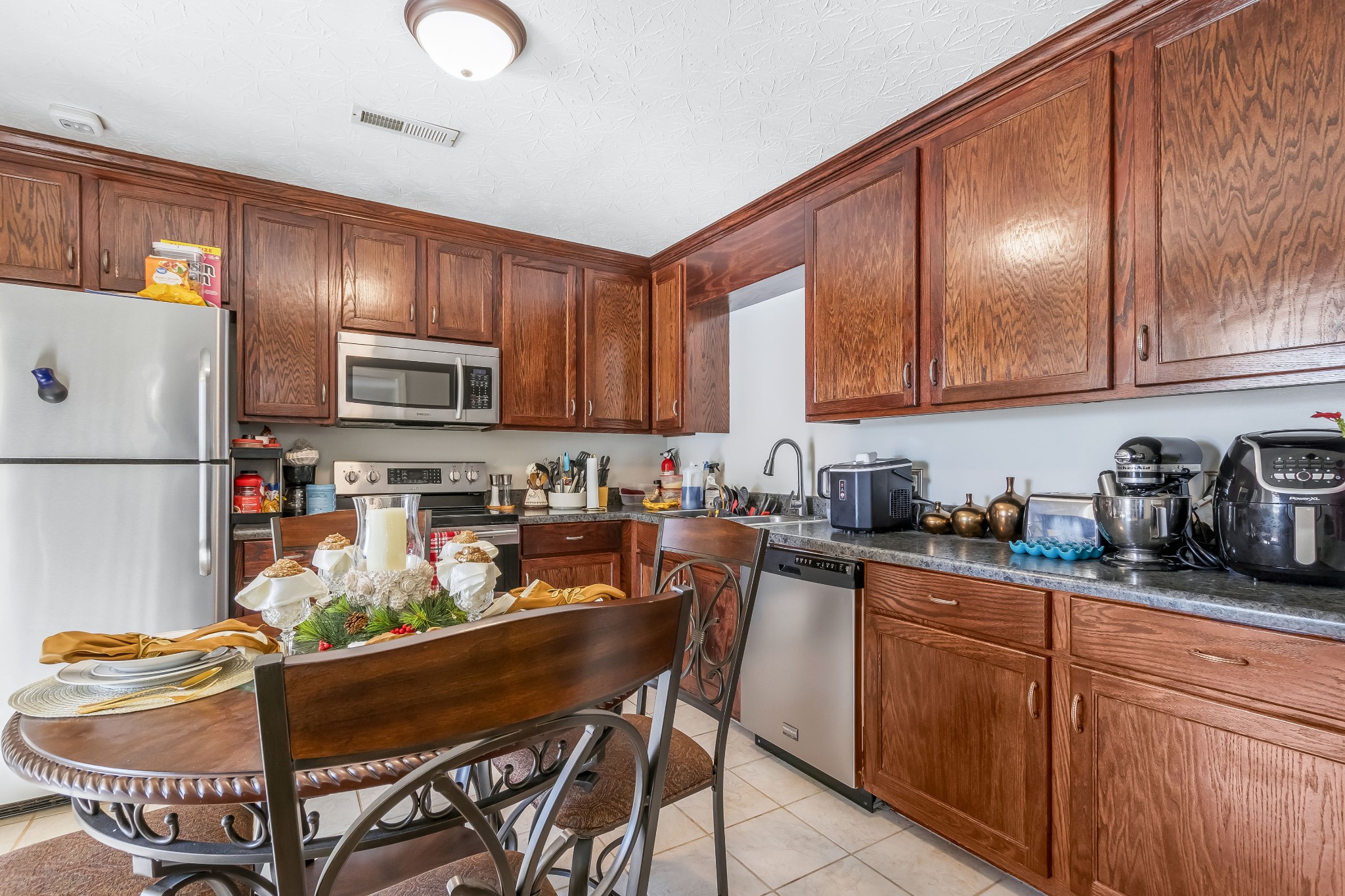 555 Randall Hitchcock Road Rock Island, TN 38581 - Photo 66 of 86 a kitchen with granite countertop lots of wooden cabinets stainless steel appliances and a refrigerator