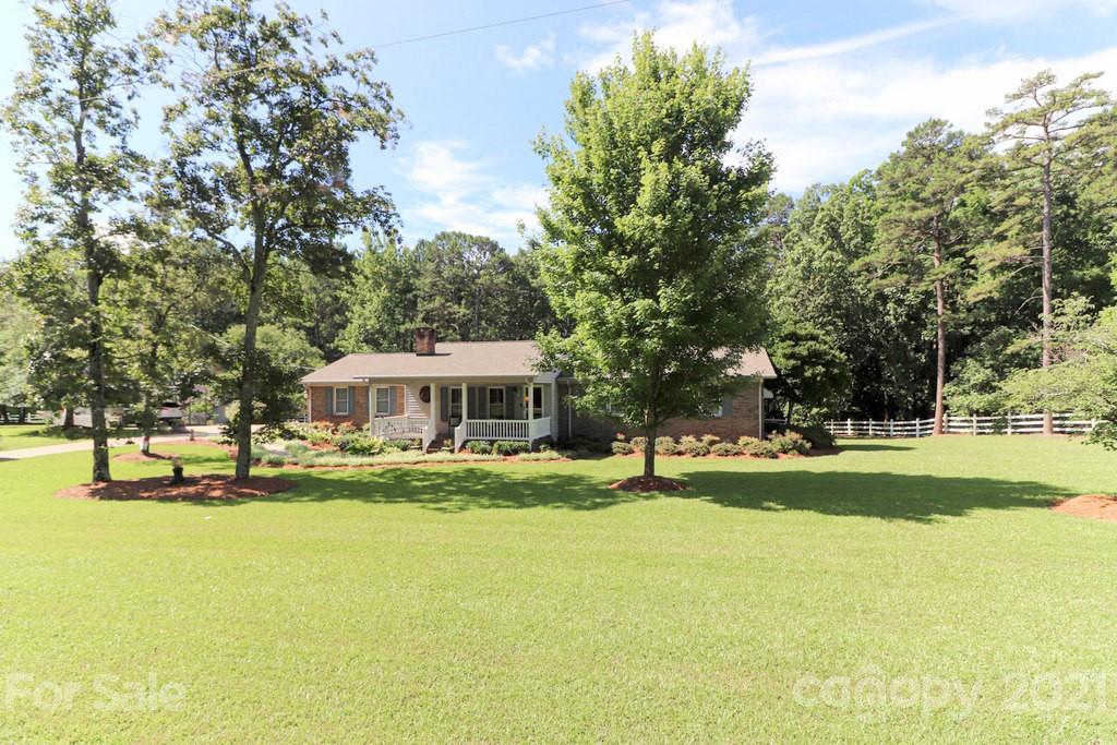 294 Holiday Road Lancaster, SC 29720 - Photo 2 of 48 a view of a house with a big yard and large trees