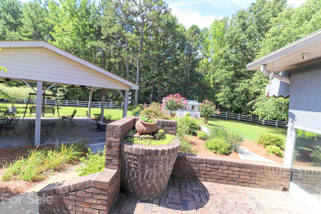 294 Holiday Road Lancaster, SC 29720 - Photo 12 of 48 a view of a patio with chair and tables back yard of the house