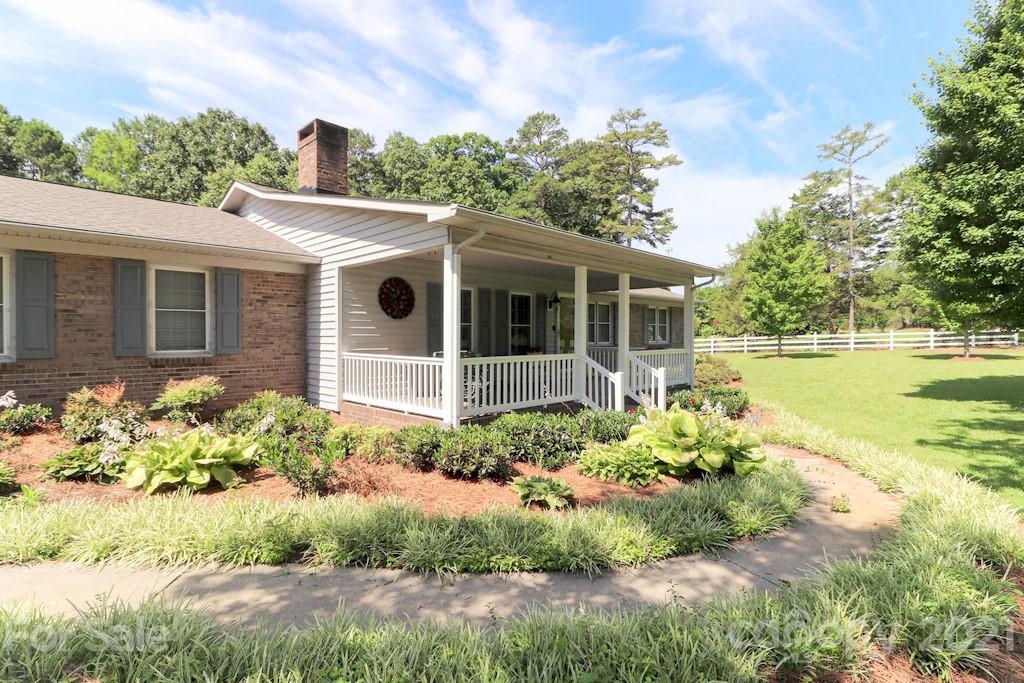 294 Holiday Road Lancaster, SC 29720 - Photo 17 of 48 a front view of a house with a yard and potted plants