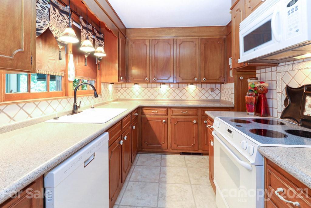 294 Holiday Road Lancaster, SC 29720 - Photo 30 of 48 a kitchen with a sink stove and cabinets