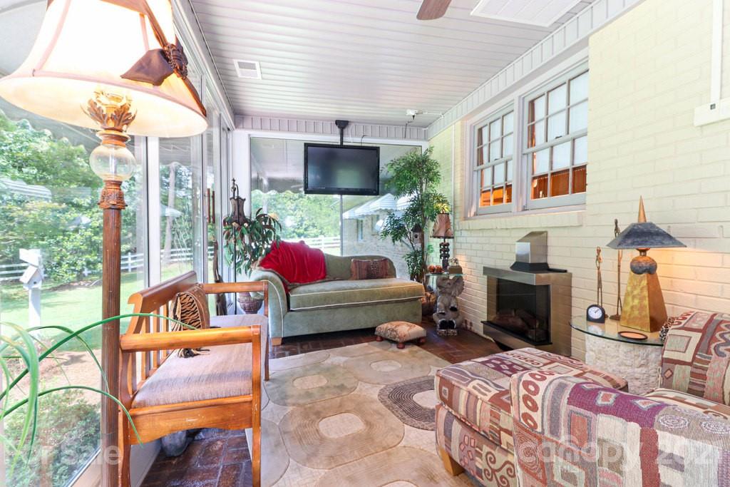 294 Holiday Road Lancaster, SC 29720 - Photo 35 of 48 a bedroom with furniture a flat screen tv and a fireplace