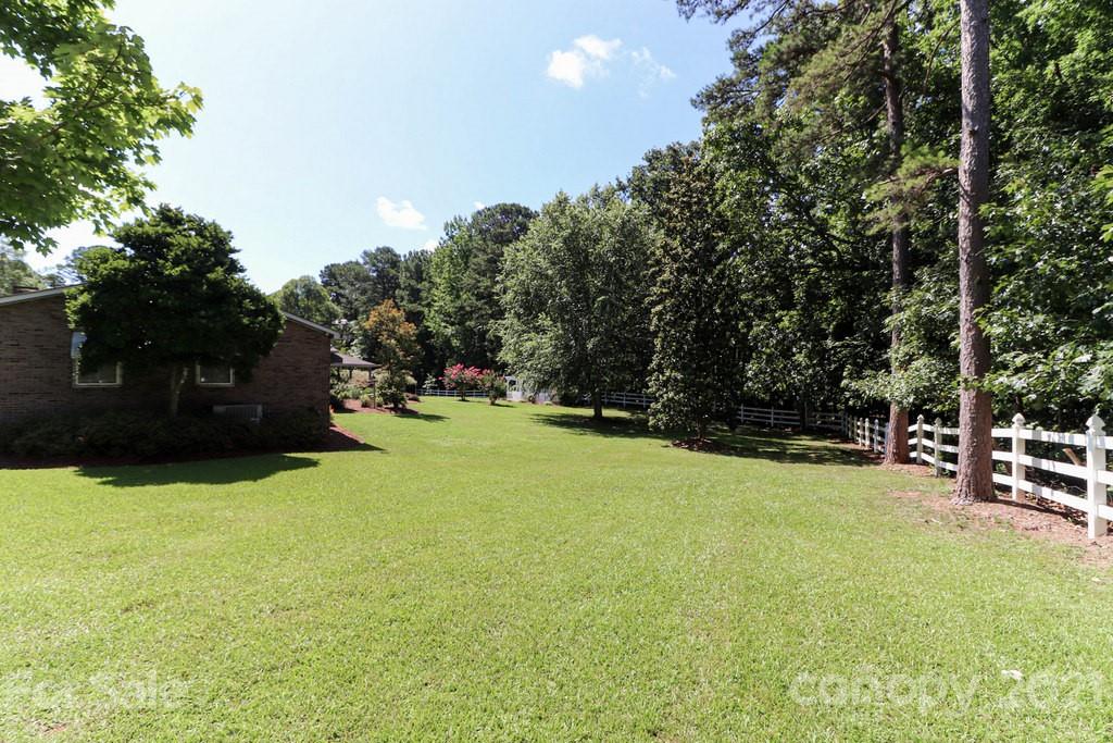 294 Holiday Road Lancaster, SC 29720 - Photo 5 of 48 a view of a green field with trees in the background