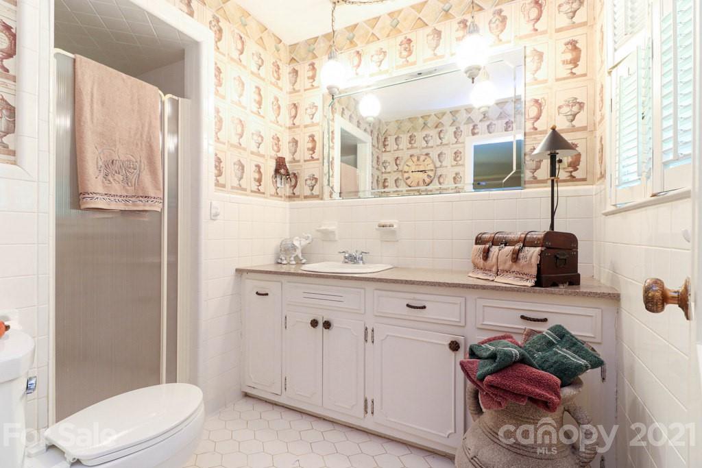 294 Holiday Road Lancaster, SC 29720 - Photo 42 of 48 a bathroom with a granite countertop sink a toilet and a shower curtain