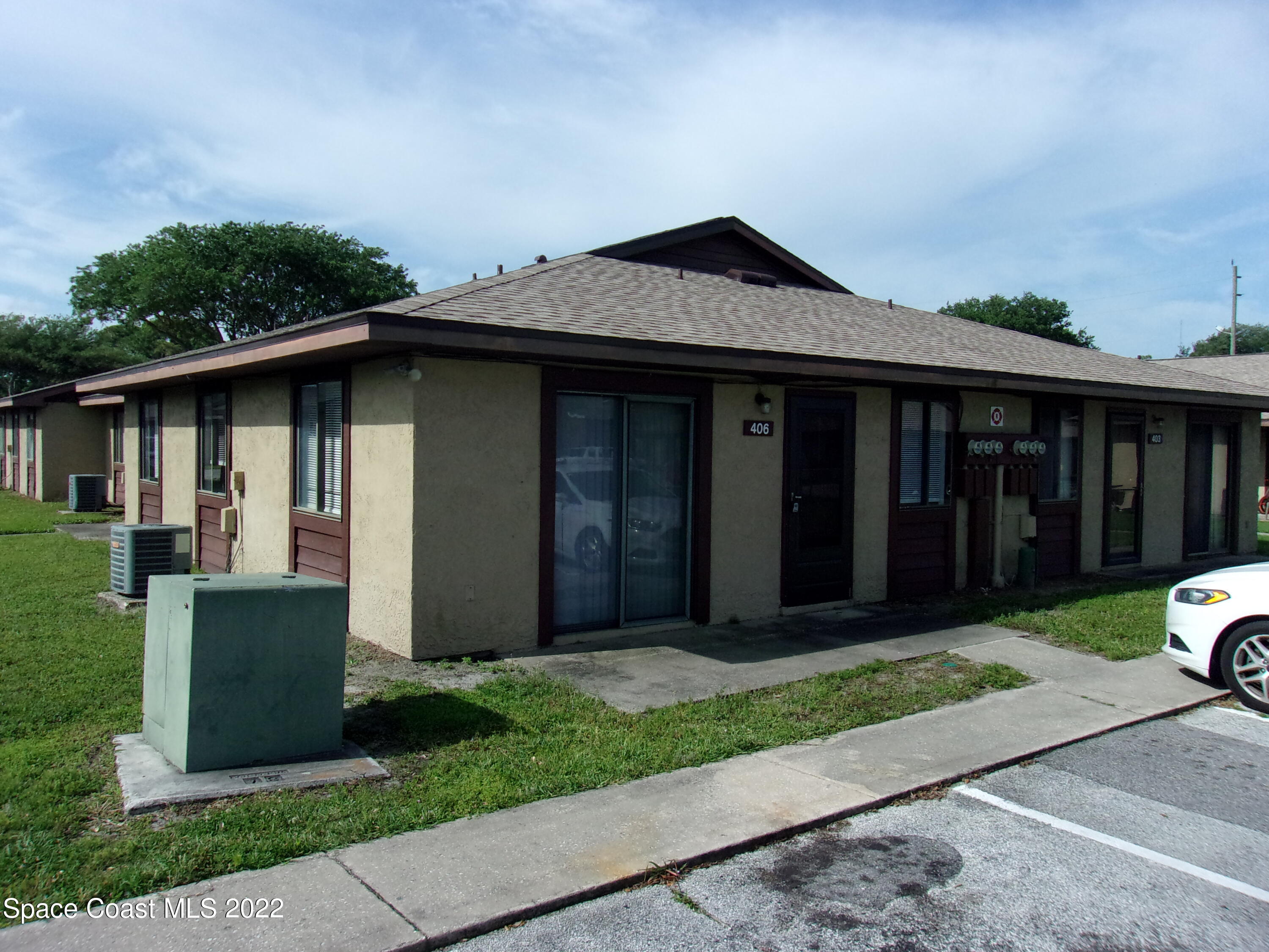 1050 North Fiske Boulevard, Unit 406 Cocoa, FL 32922 - Photo 1 of 11 a front view of a house with a yard