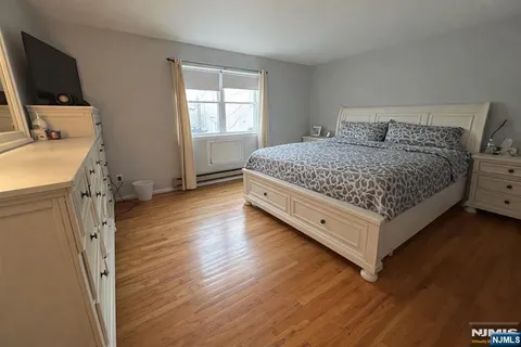 a bedroom with a bed and flat screen tv
