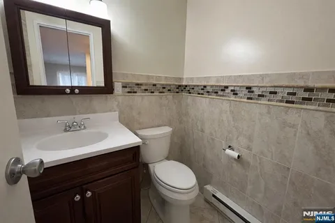 a bathroom with a sink a toilet and mirror