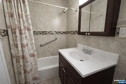 a bathroom with a sink a mirror and a shower