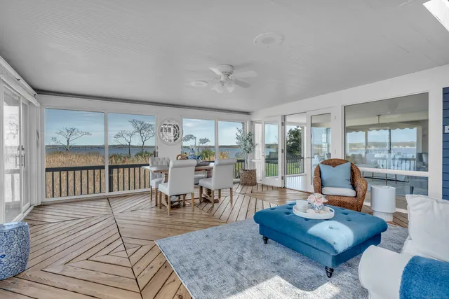 a living room with furniture and a floor to ceiling window