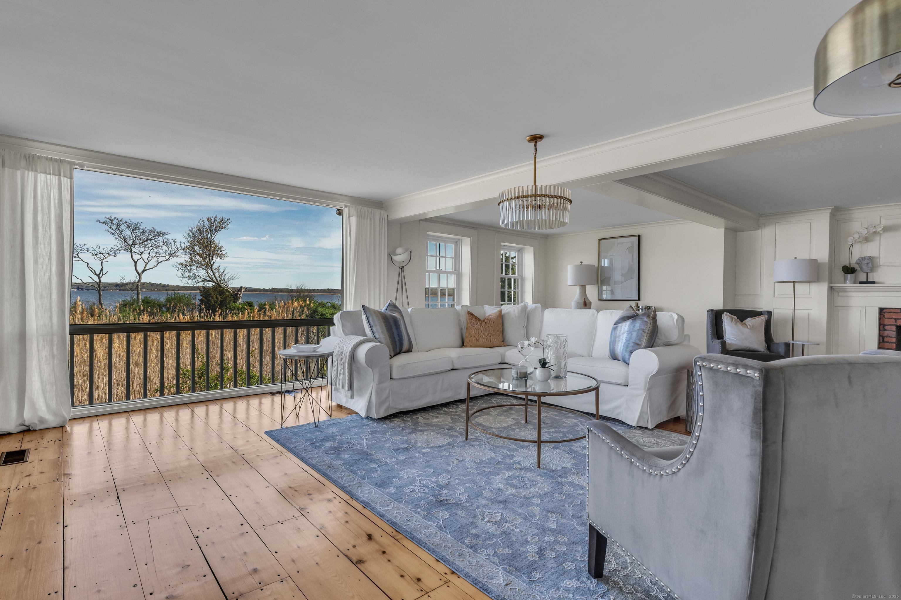 175 North Cove Road Old Saybrook, CT 06475 - Photo 15 of 40 a living room with furniture and a large window