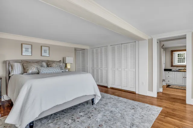 a bathroom with a granite countertop sink toilet and mirror
