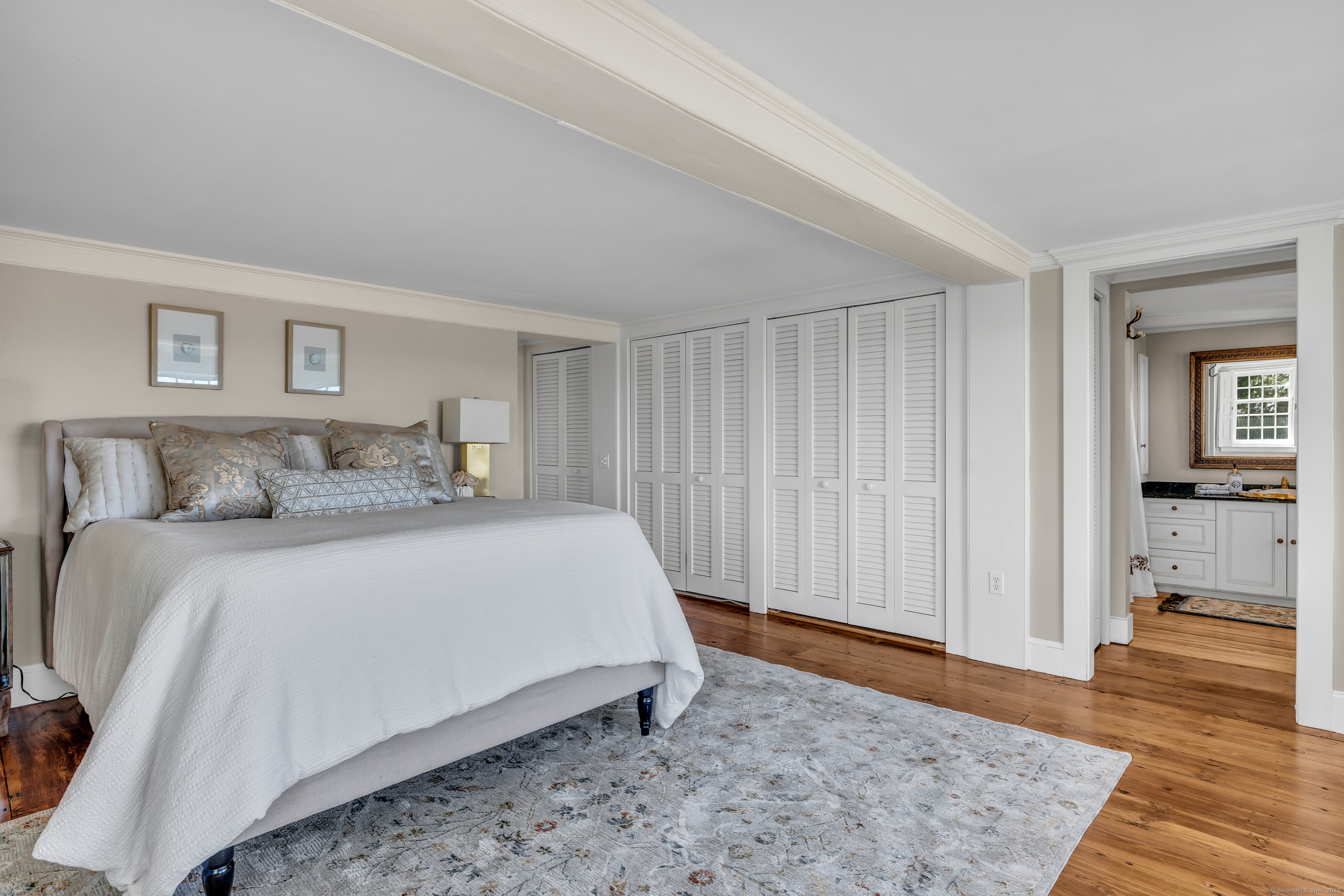 175 North Cove Road Old Saybrook, CT 06475 - Photo 20 of 40 a spacious bedroom with a bed and wooden floor