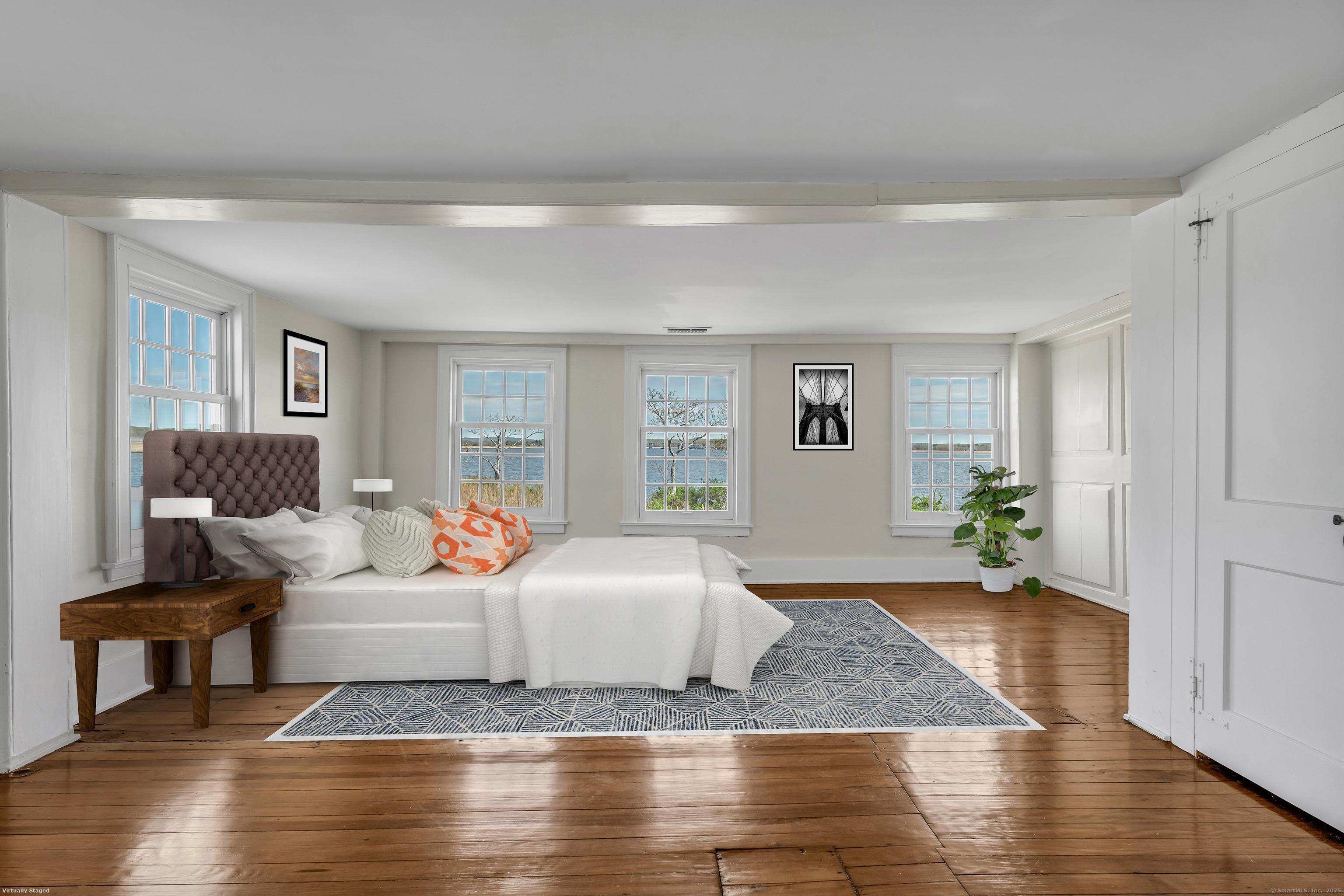 175 North Cove Road Old Saybrook, CT 06475 - Photo 23 of 40 a bedroom with a bed and wooden floor
