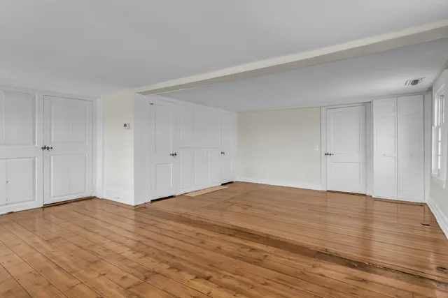 a bathroom with a granite countertop sink a large mirror and a bathtub
