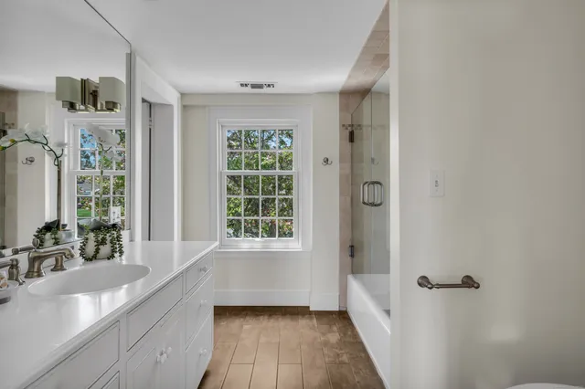 a bedroom with bed and a potted plant