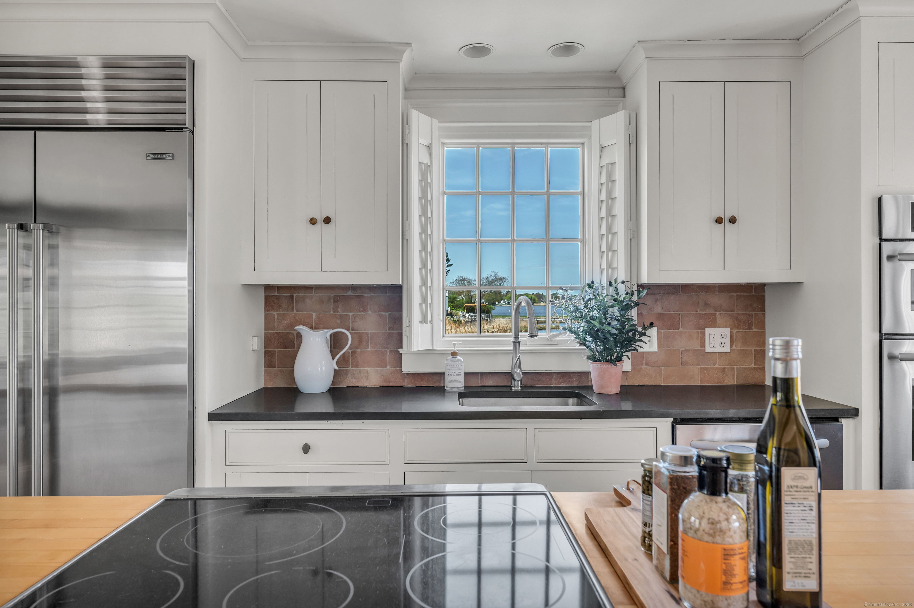 175 North Cove Road Old Saybrook, CT 06475 - Photo 10 of 40 a kitchen with stainless steel appliances granite countertop a sink and a refrigerator