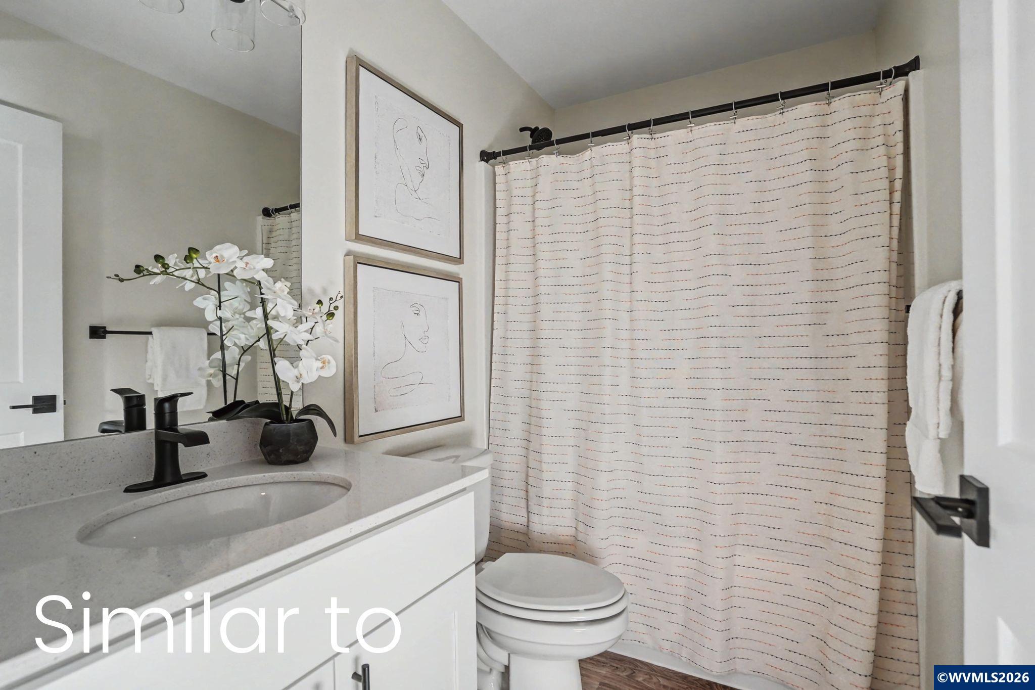 2550 Promise Way Lebanon, OR 97355 - Photo 27 of 35 a bathroom with a sink a toilet and shower curtain