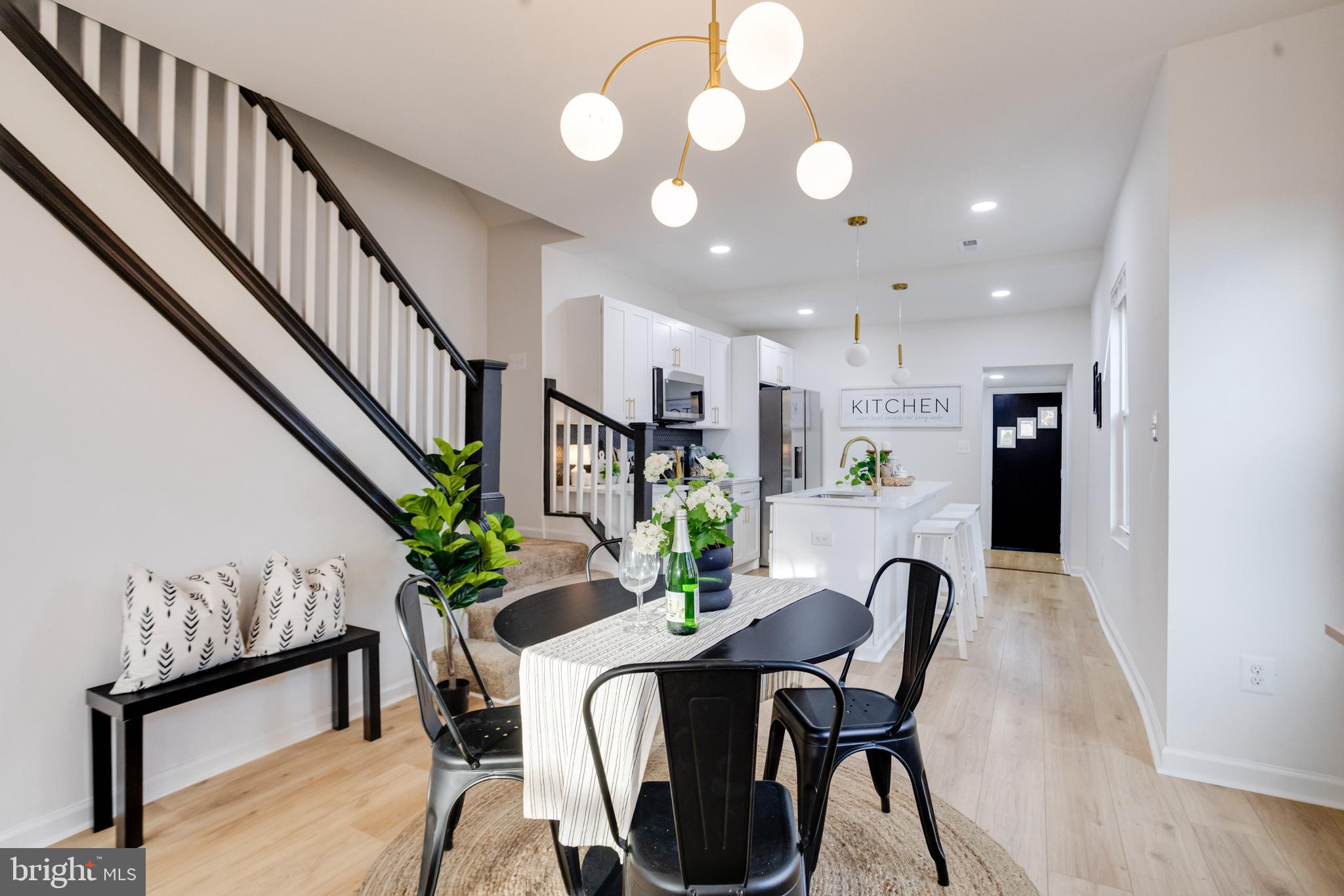 5805 Highgate Drive Baltimore, MD 21215 - Photo 14 of 69 a view of a dining room with furniture and a potted plant
