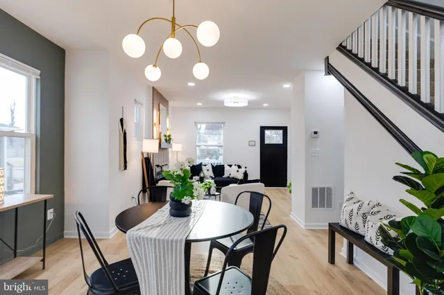 a view of a dining room with furniture and a potted plant