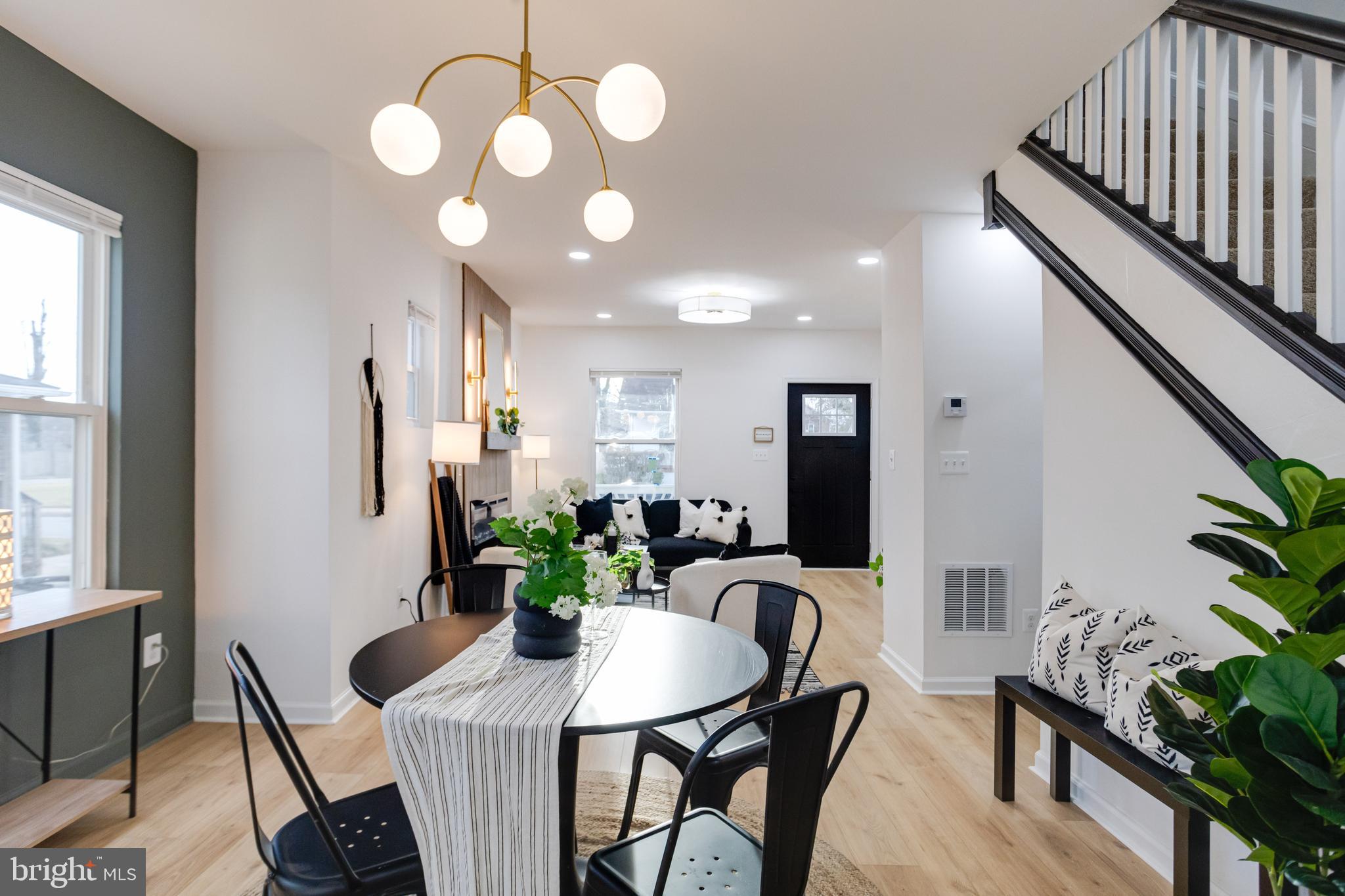 5805 Highgate Drive Baltimore, MD 21215 - Photo 16 of 69 a view of a dining room with furniture and a potted plant