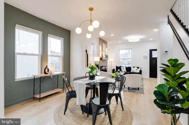 a view of a dining room with furniture and a potted plant