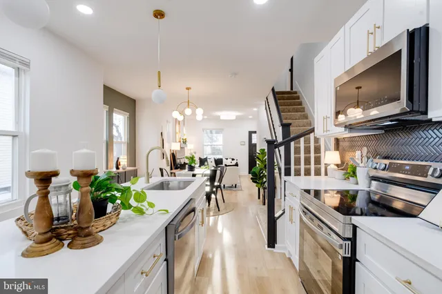 a kitchen with counter top space appliances and wooden floor