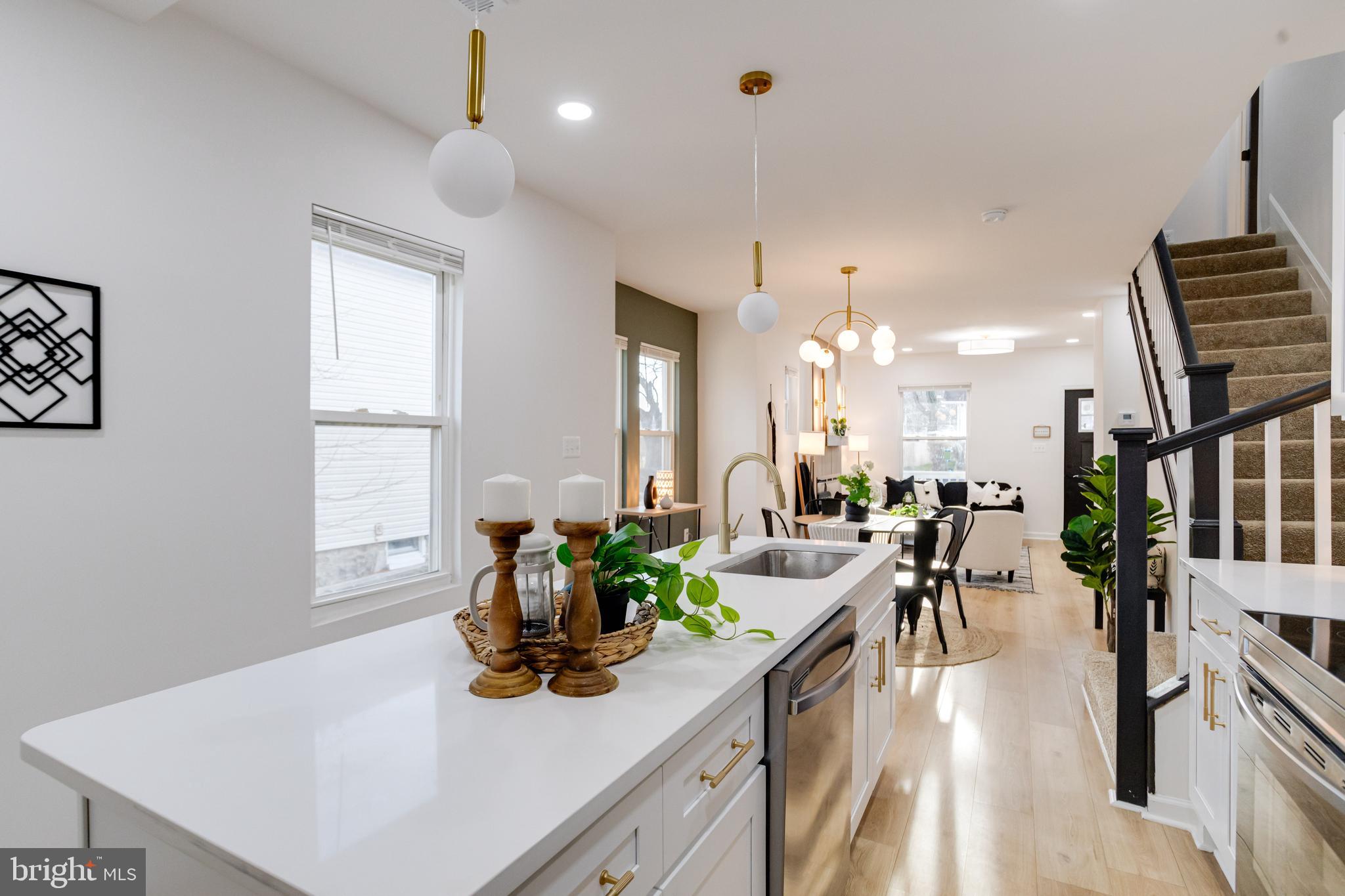 5805 Highgate Drive Baltimore, MD 21215 - Photo 22 of 69 a view of a dining room and livingroom with furniture wooden floor a chandelier