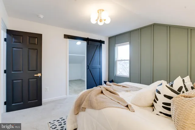 a bathroom with a sink a toilet a mirror and shower