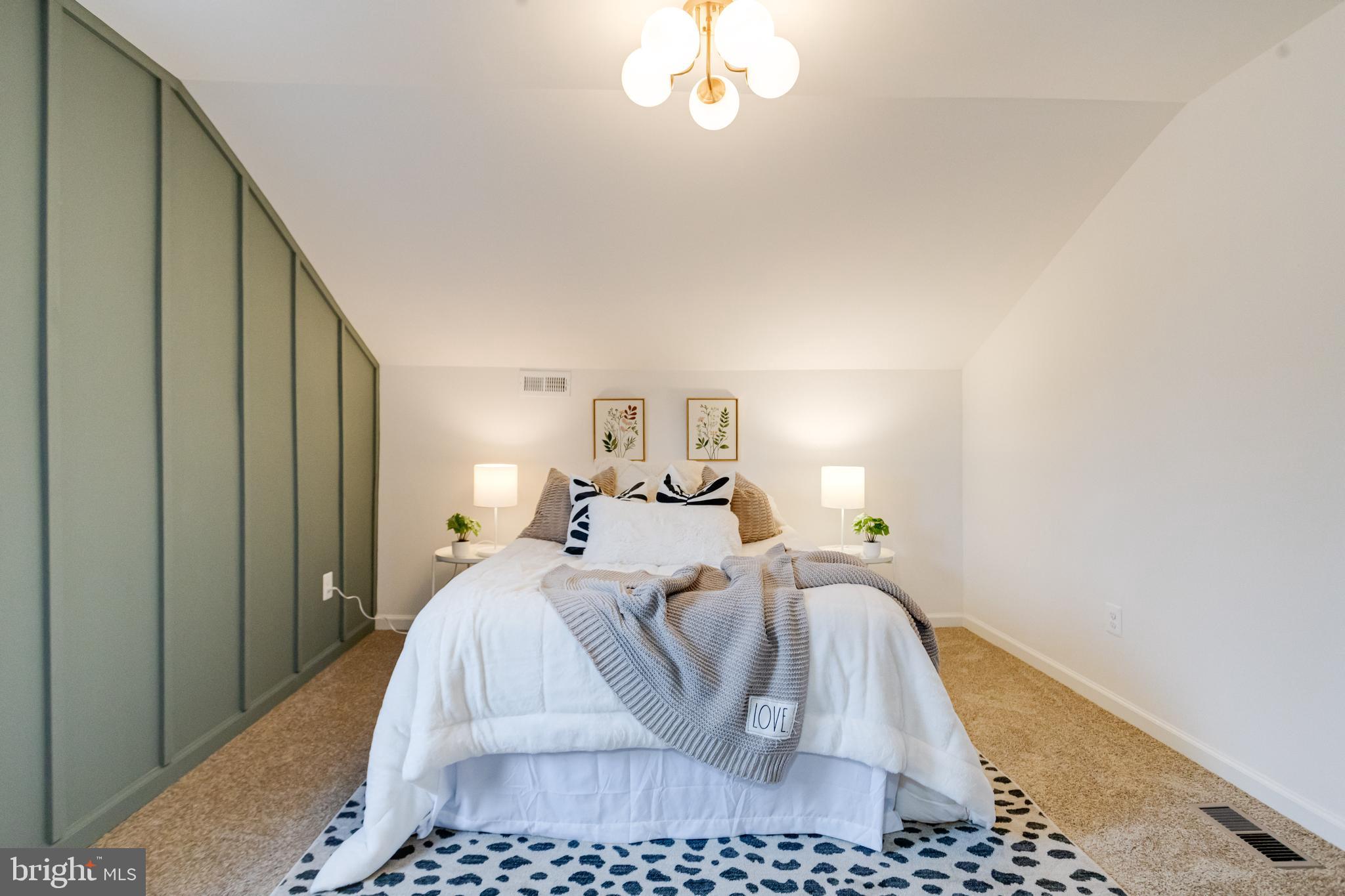 5805 Highgate Drive Baltimore, MD 21215 - Photo 38 of 69 a bed room with a bed and a chandelier