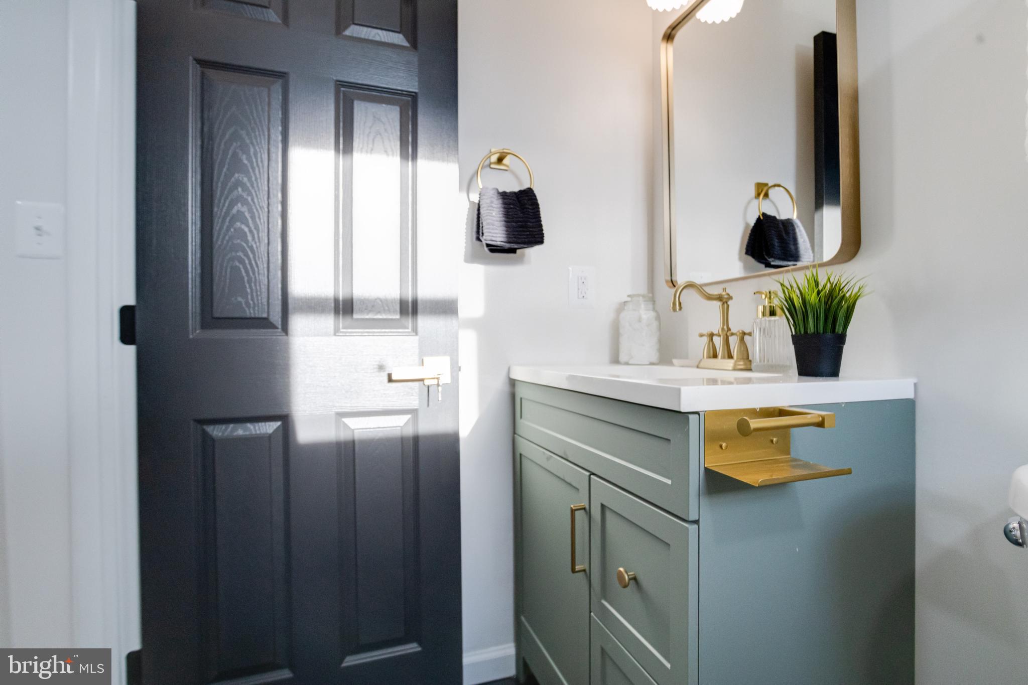 5805 Highgate Drive Baltimore, MD 21215 - Photo 44 of 69 a bathroom with a sink and a mirror