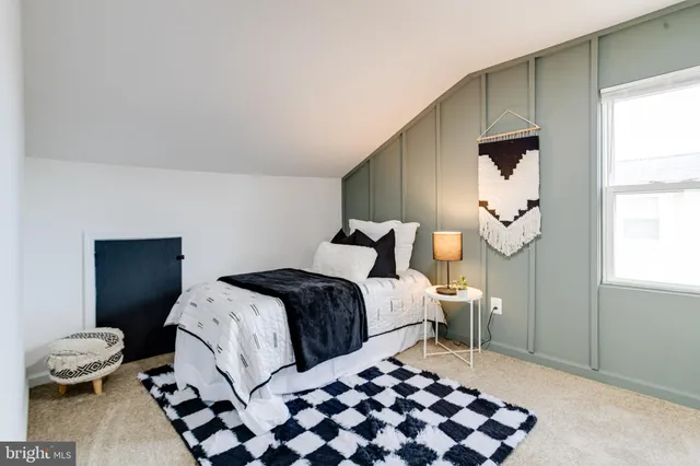 a living room with furniture potted plant and a window