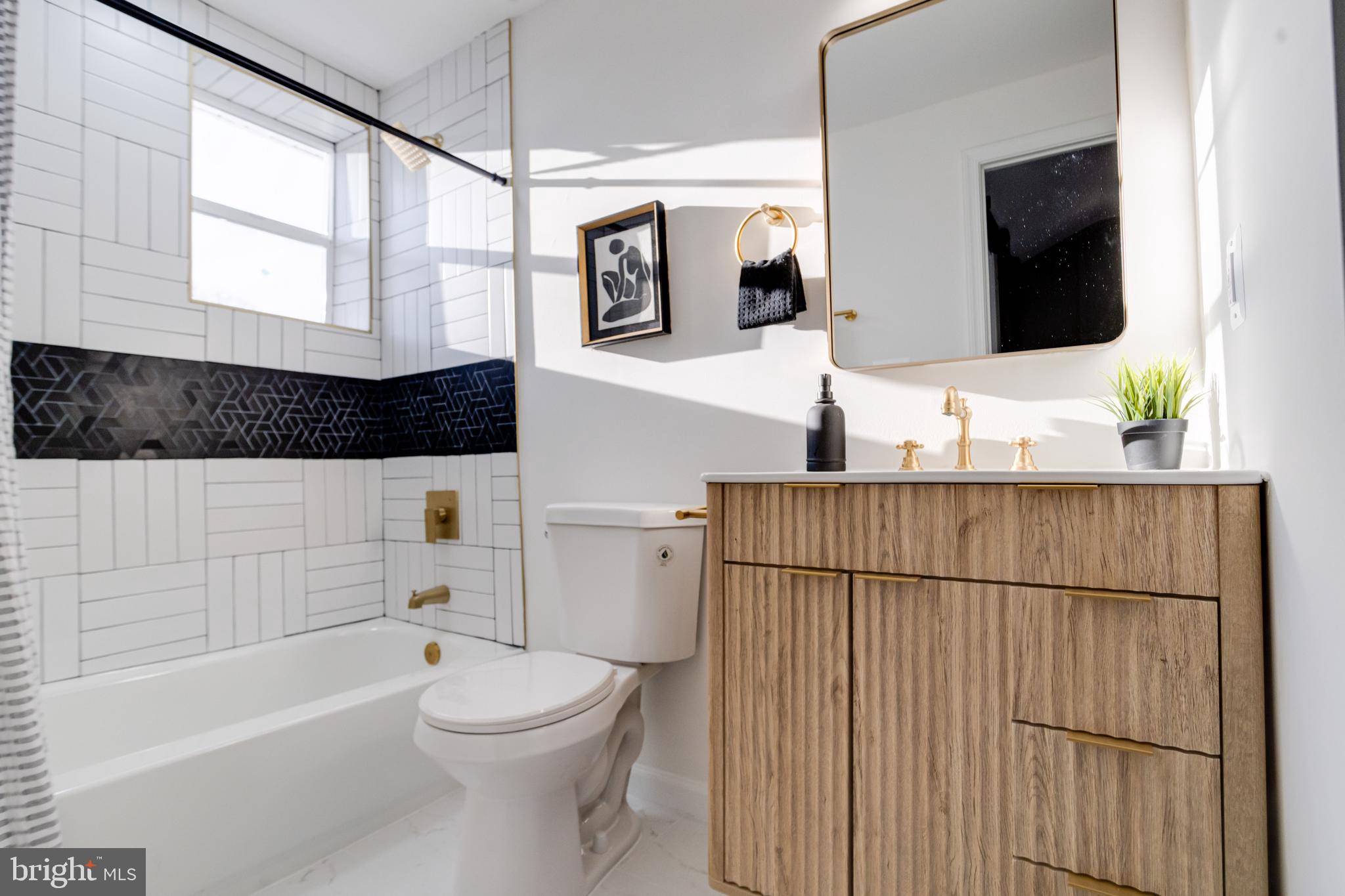 5805 Highgate Drive Baltimore, MD 21215 - Photo 50 of 69 a bathroom with a sink a toilet a mirror and shower