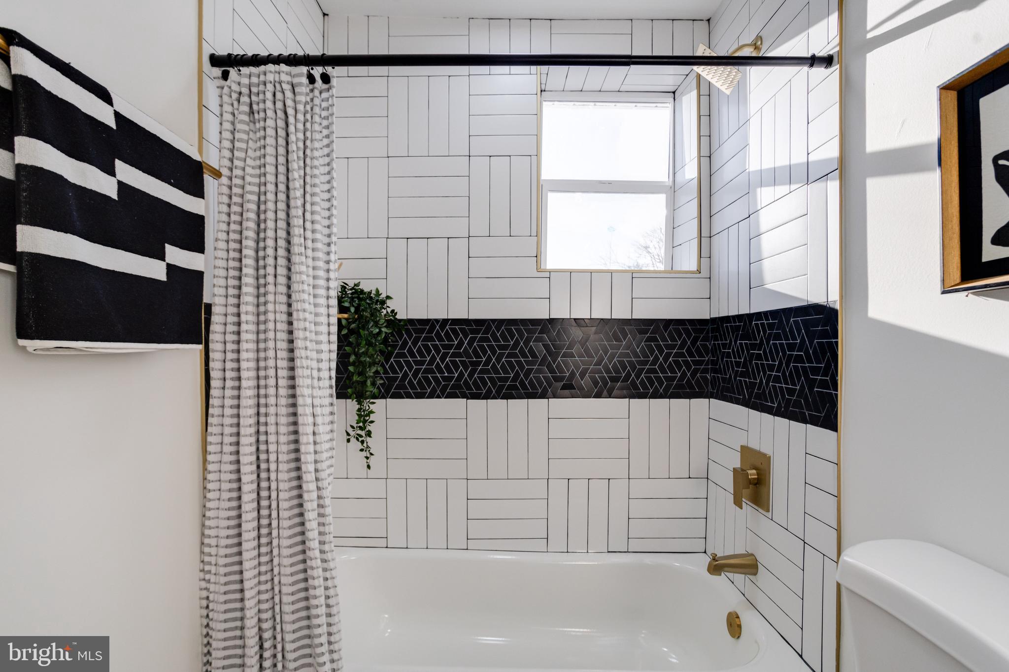 5805 Highgate Drive Baltimore, MD 21215 - Photo 51 of 69 a bathroom with a bathtub and a shower