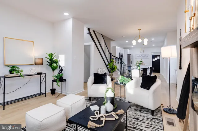 a living room with furniture and a chandelier