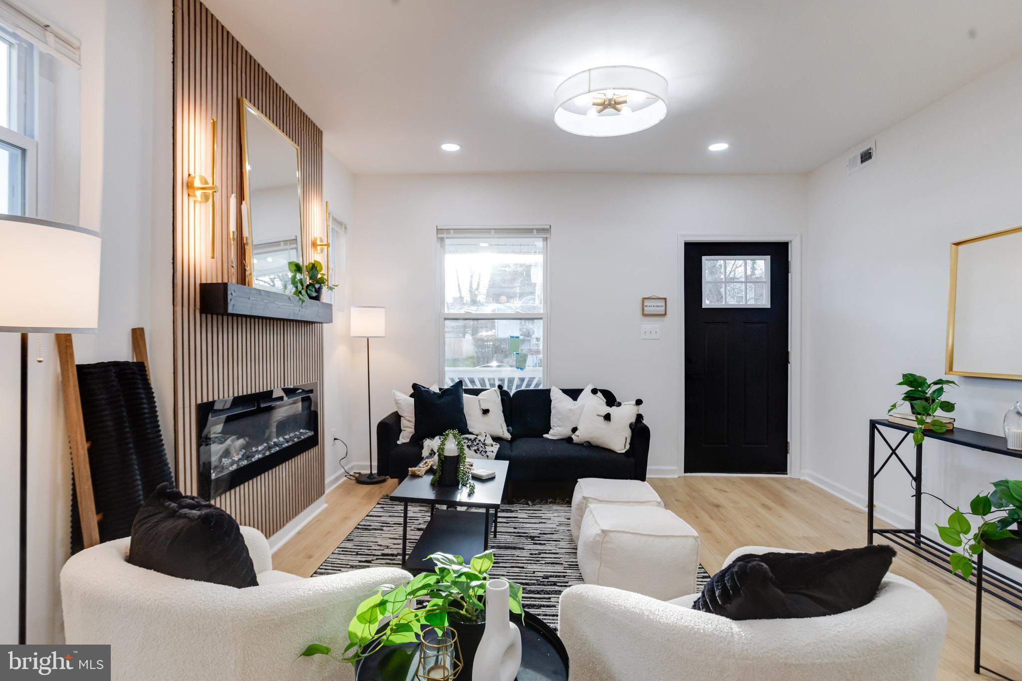 5805 Highgate Drive Baltimore, MD 21215 - Photo 10 of 69 a living room with furniture a fireplace a potted plant and a window
