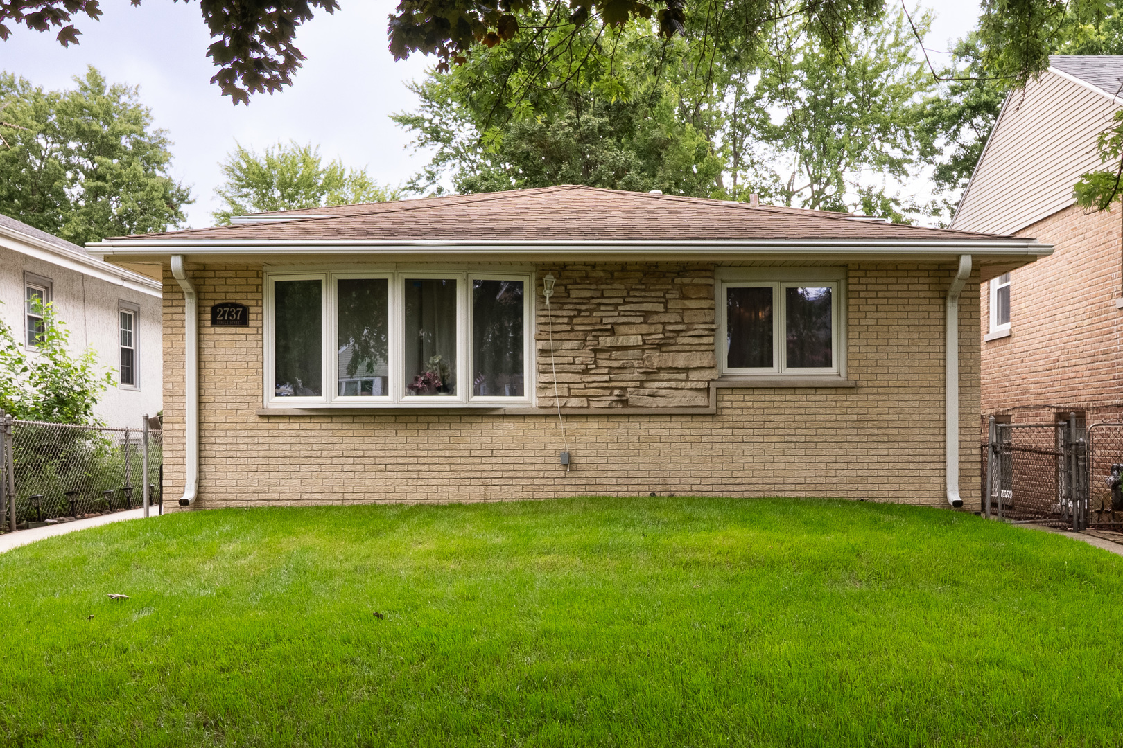 2737 Spruce Street River Grove, IL 60171 - Photo 2 of 30 a front view of a house with a garden