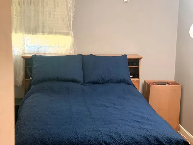 a room with a bed and a window