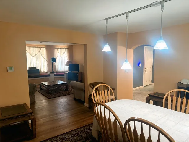 a kitchen with a table chairs and a dining table