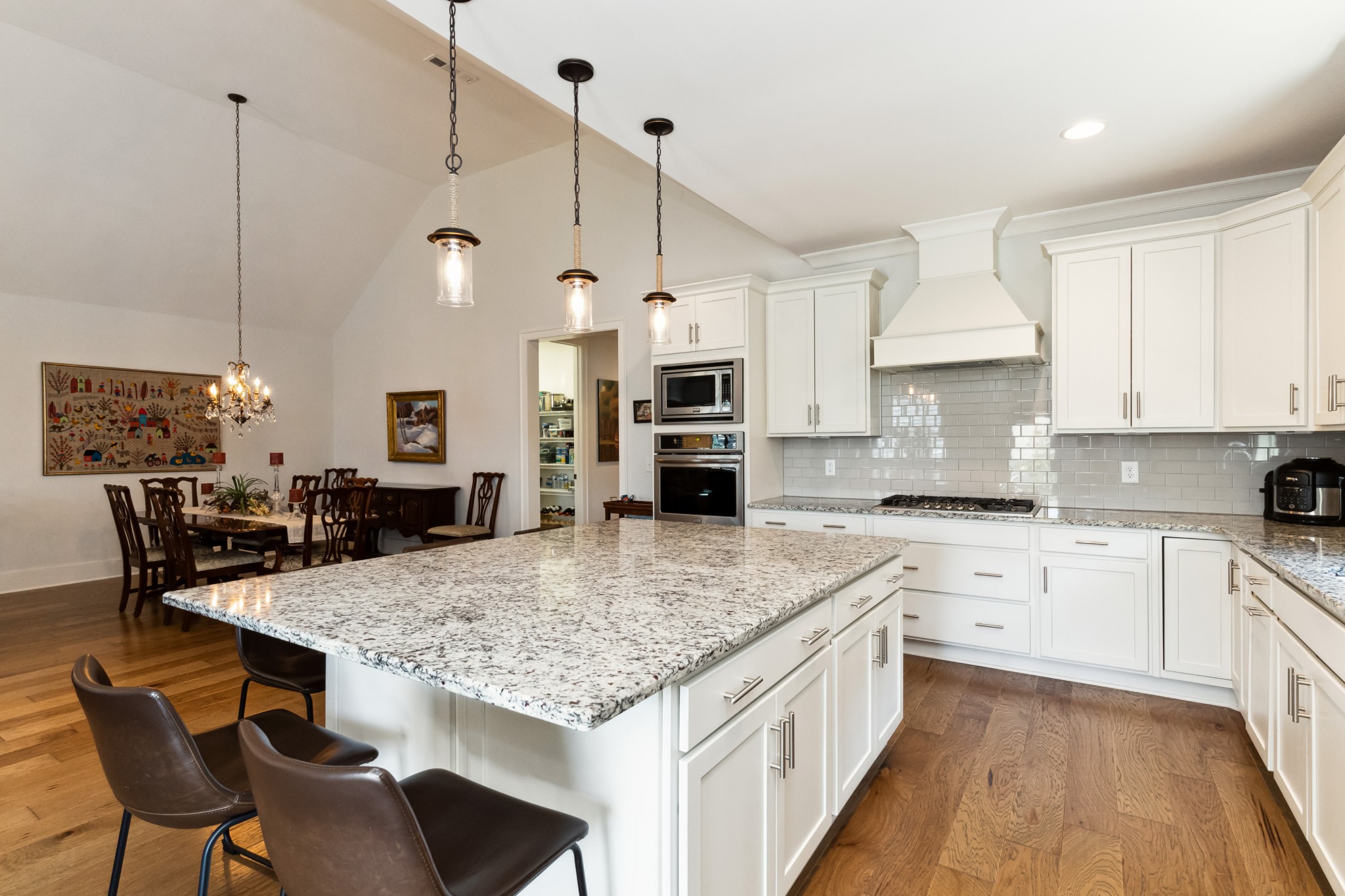 114 Vanner Road Mount Juliet, TN 37122 - Photo 14 of 39 a kitchen with stainless steel appliances granite countertop a kitchen island a stove a table and chairs
