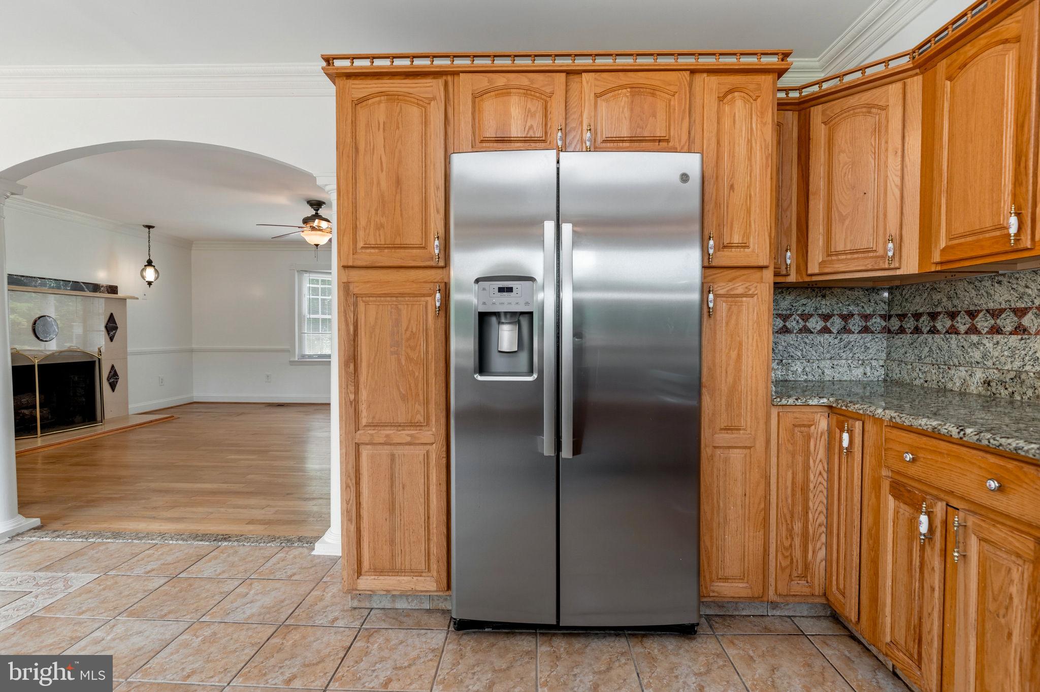 11325 Bacon Race Road Woodbridge, VA 22192 - Photo 16 of 54 a kitchen with stainless steel appliances granite countertop a refrigerator and a sink