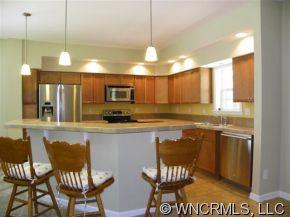 232 Long Road Bostic, NC 28018 - Photo 5 of 12 a kitchen with stainless steel appliances granite countertop a stove top oven a sink a dining table and chairs
