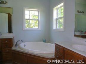 232 Long Road Bostic, NC 28018 - Photo 9 of 12 a white bath tub sitting in a bathroom next to a window