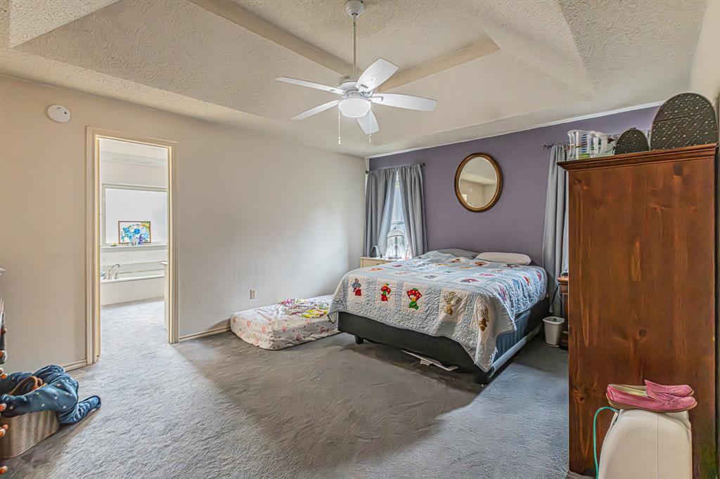 3309 Timber View Circle Bedford, TX 76021 - Photo 23 of 38 a bedroom with a bed and a chandelier