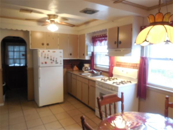 38 Whitman Street Chicopee, MA 01013 - Photo 8 of 15 a kitchen with stainless steel appliances kitchen island granite countertop a refrigerator and a stove