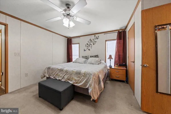 a spacious bedroom with a bed and a chandelier