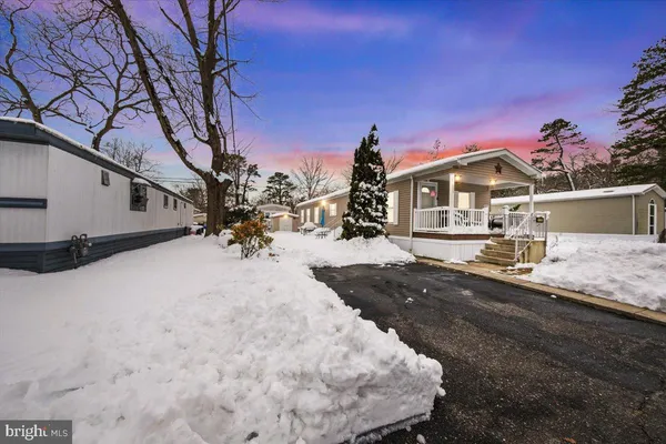 a view of a house with a snow in a yard